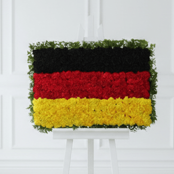 Germany flag floral arrangement on a thick white easel with wainscoting background